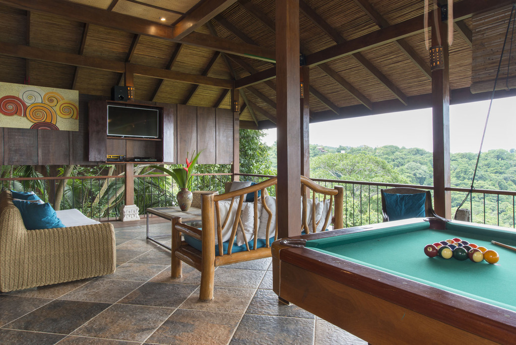 The games room on the third level features a regulation pool table, smart TV, and plenty of luxury seating.