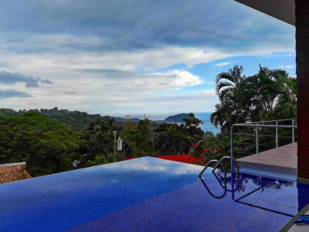 Your infinity pool has an incredible view of the Pacific ocean, vibrant coastal jungle, and the big blue sky.