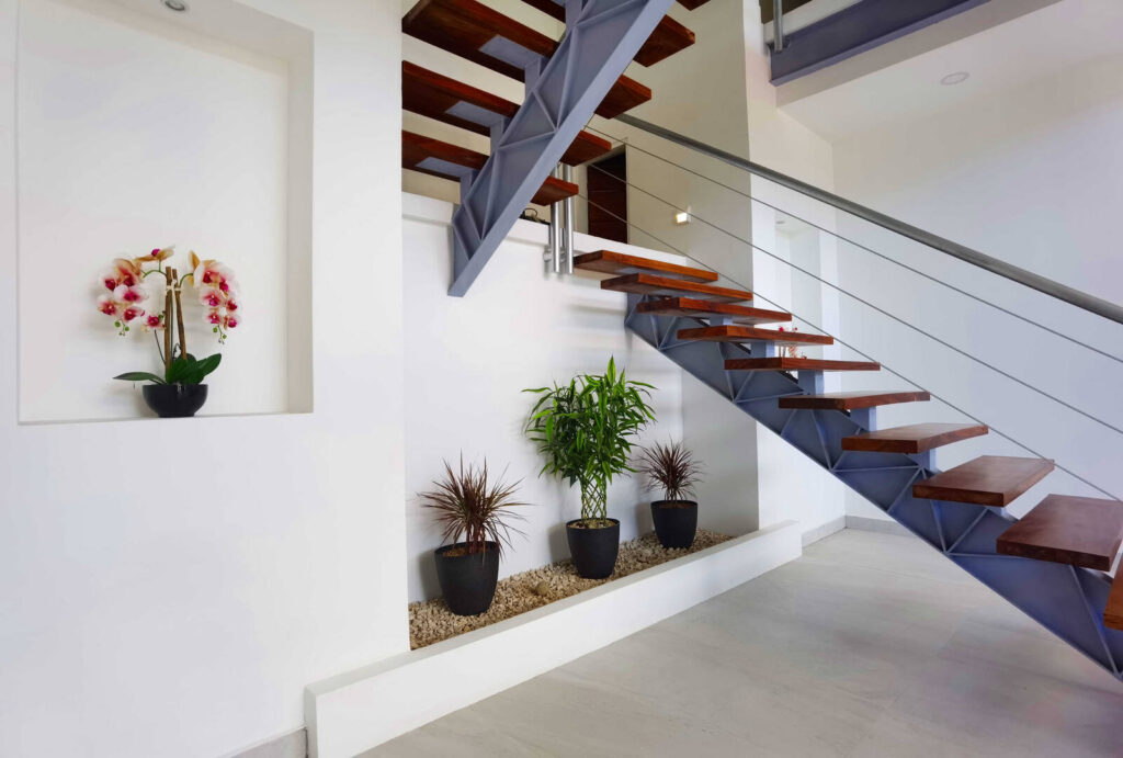 Exotic plants and clean white interiors throughout this stunning house give it a calm relaxing vibe.