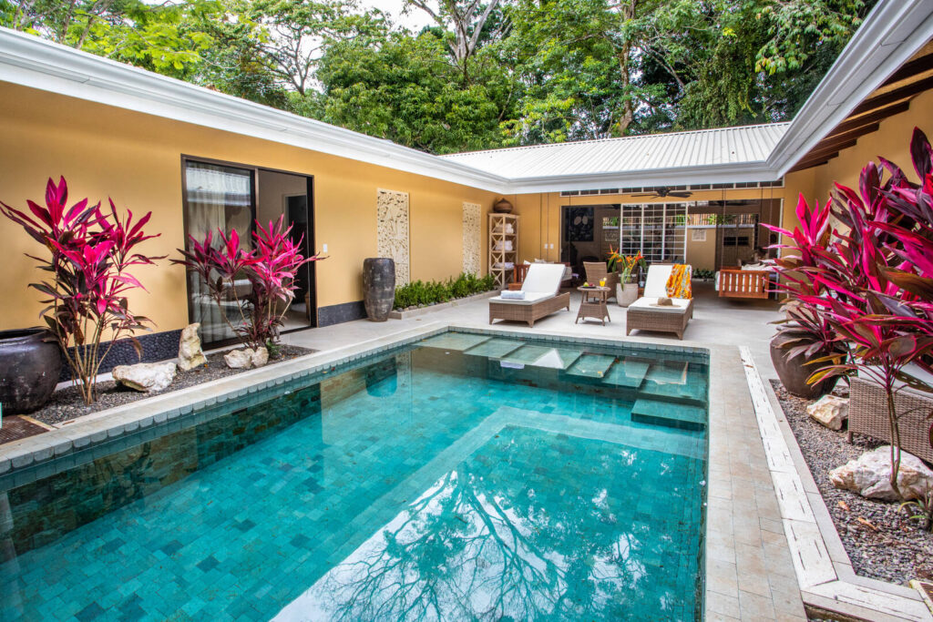 The incredible courtyard-style pool area is secluded and accessible from two bedrooms and the open living area. 