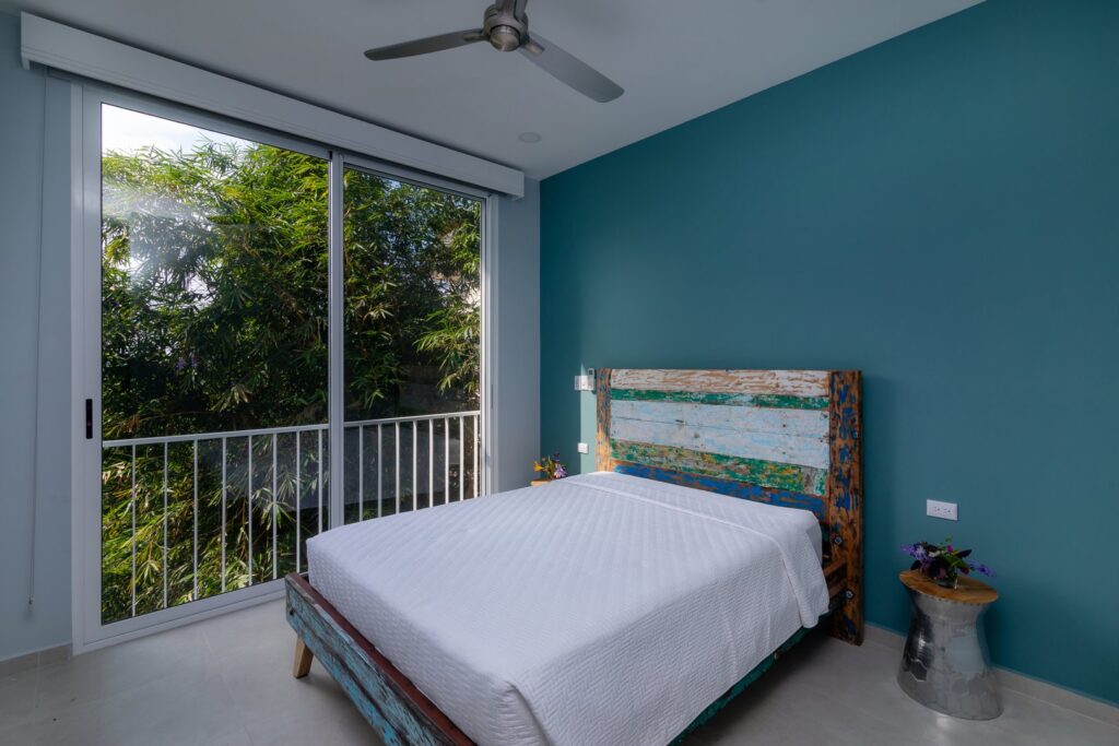This queen bedroom has sliding glass doors that open to let in the rainforest sounds and breezes.