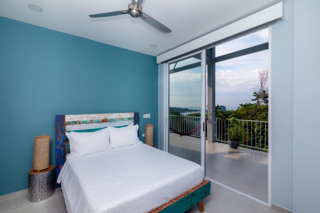 This bedroom comes with access to the terrace and beautiful ocean and rainforest views.