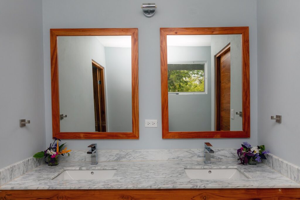 This bathroom features a beautiful marble counter double vanity sink.