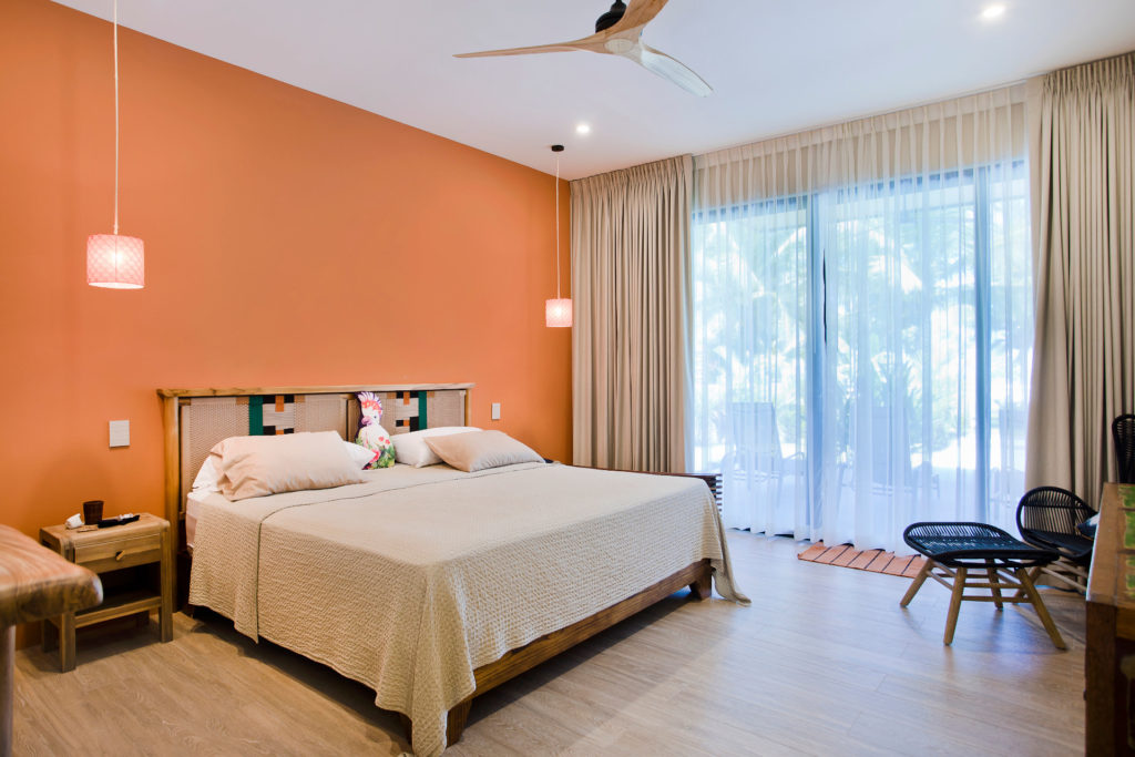 Stunning fully-airconditioned master bedroom with king-size bed and a view to tropical gardens.