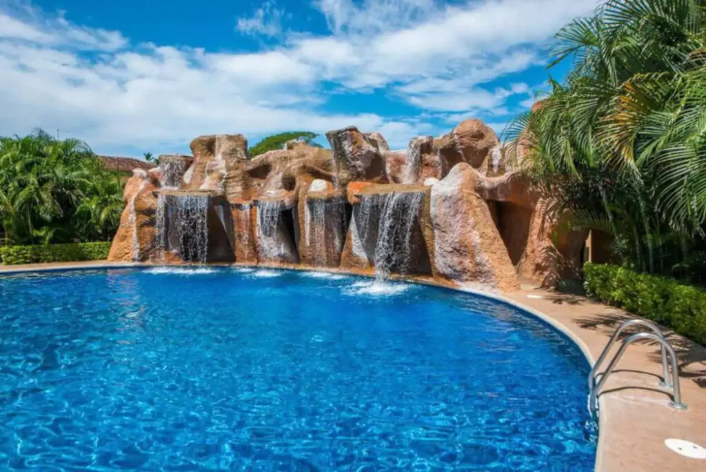 The huge inviting pool has an awesome cascading waterfall at one end.