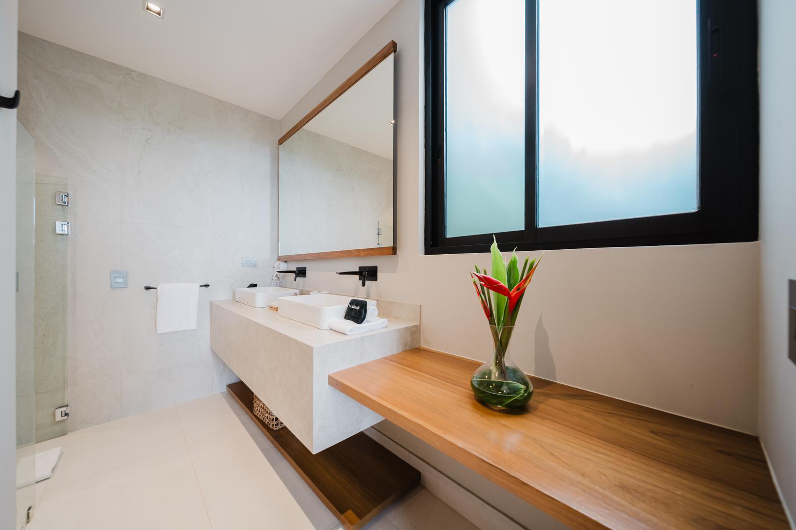 Modern bathroom with double vanity, vessel sinks, and natural light in Manuel Antonio Costa Rica