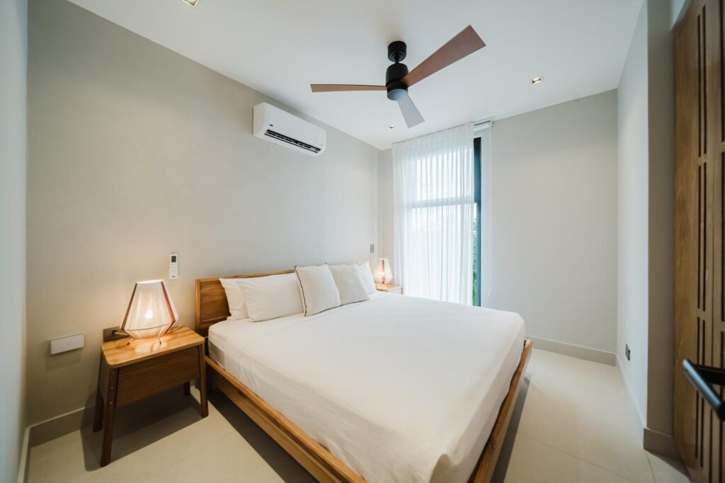 A calm, minimalist bedroom designed for rest and quiet comfort.