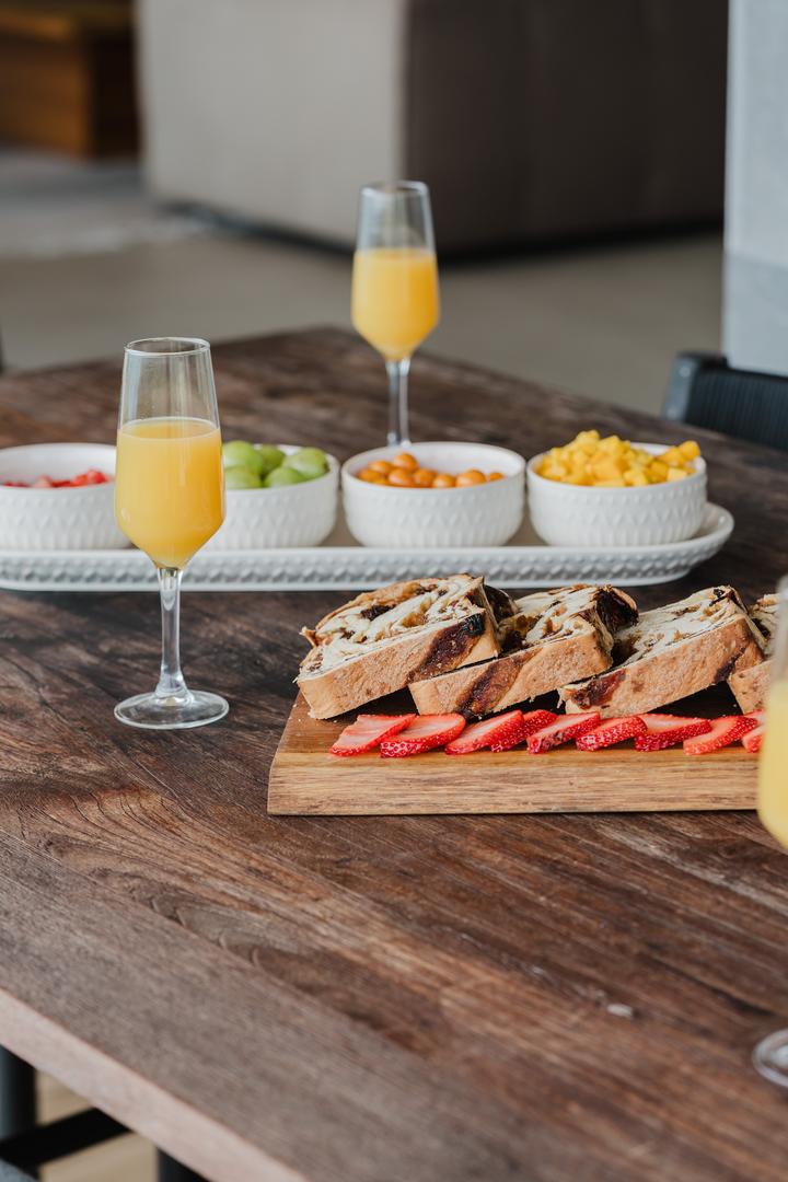 Gourmet breakfast with fruit sandwiches and mimosas on wooden table in Manuel Antonio Costa Rica