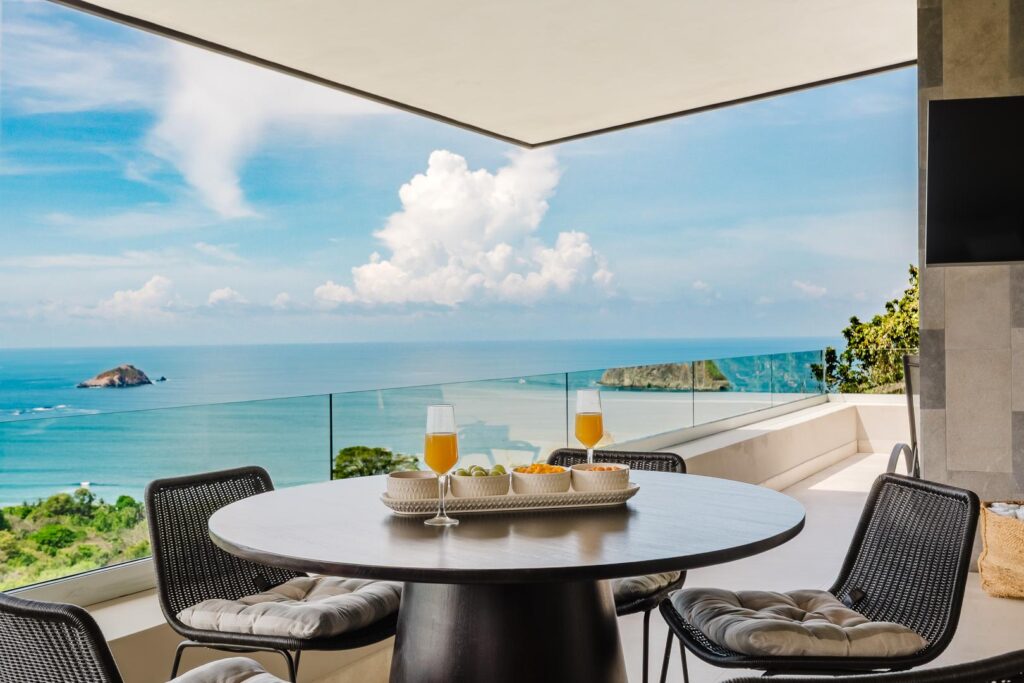 Outdoor dining table with chairs overlooking the Pacific Ocean in Manuel Antonio Costa Rica