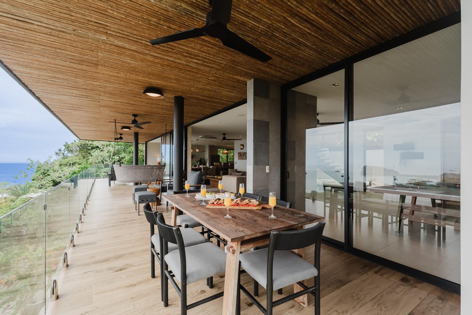 Outdoor dining table on covered terrace with ocean view in Manuel Antonio Costa Rica