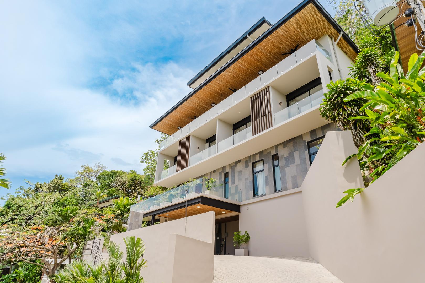Modern luxury villa exterior with multiple levels and balconies in Manuel Antonio Costa Rica