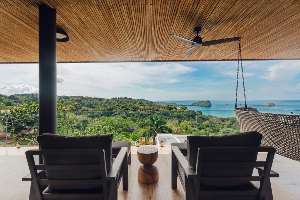 A front-row perspective where jungle canopy and ocean horizon come together.