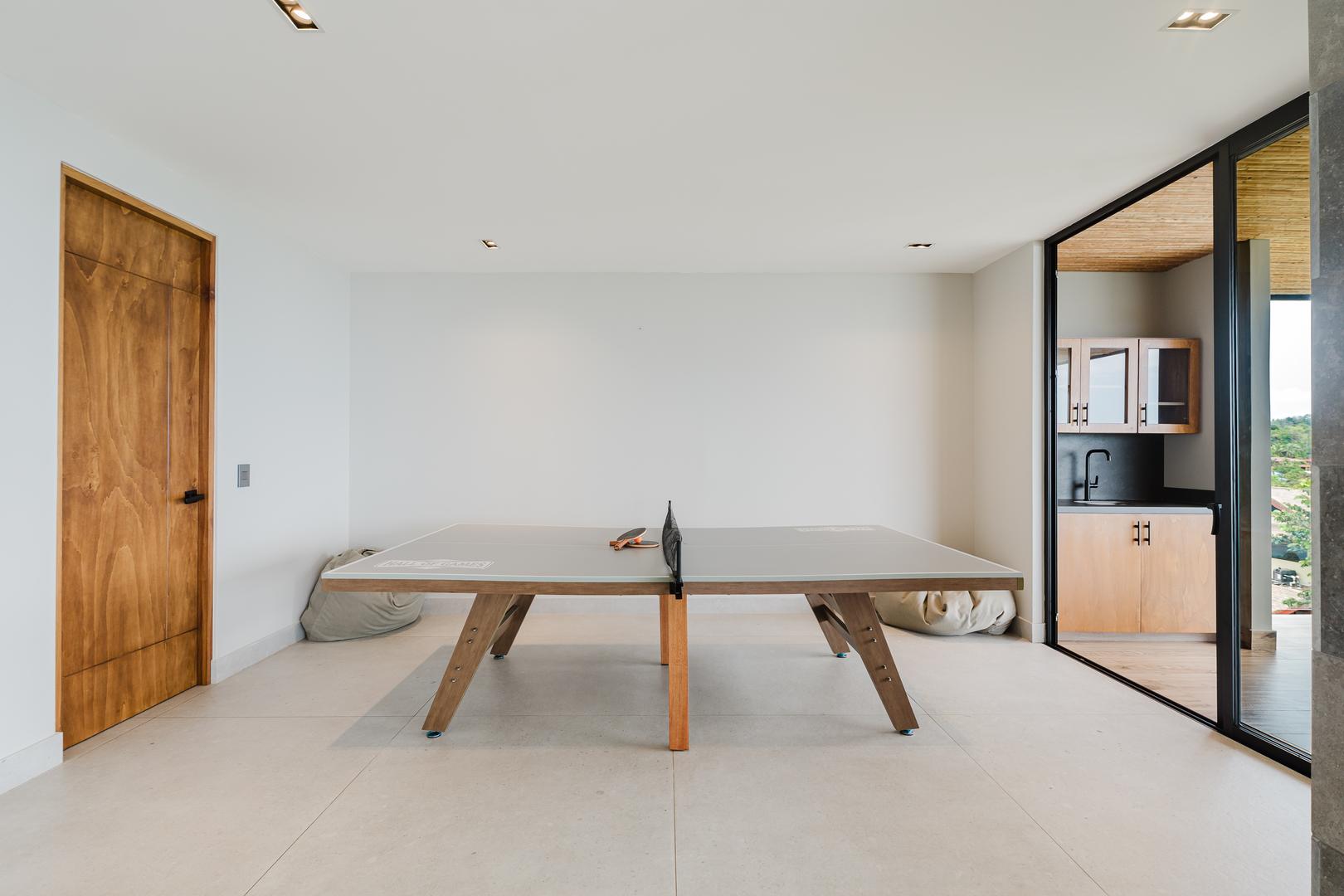 Indoor ping pong table in modern game room with sliding glass doors Manuel Antonio Costa Rica