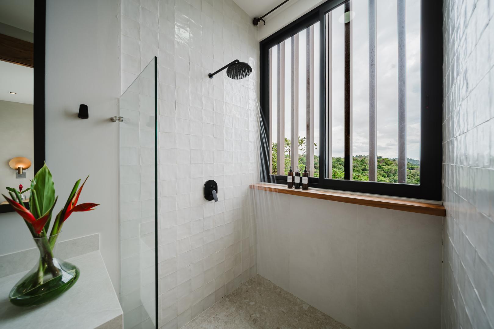 Modern rainfall shower with window and jungle view in Manuel Antonio Costa Rica