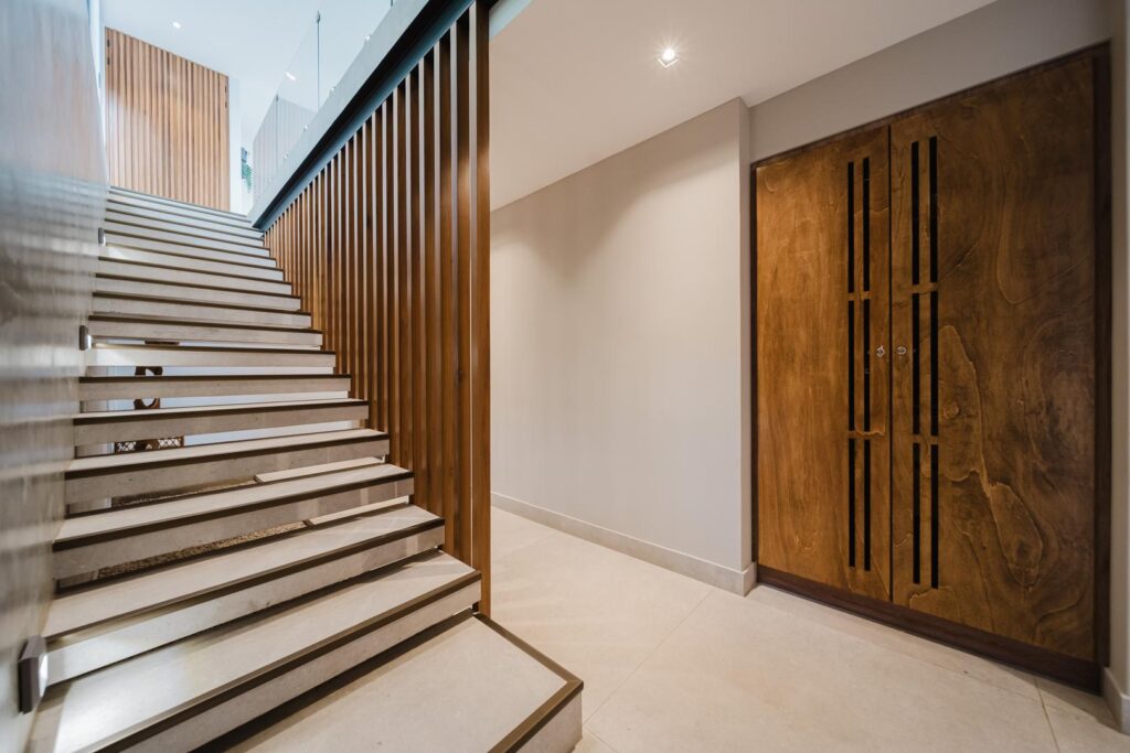 A sleek staircase with warm wood accents and clean architectural lines.