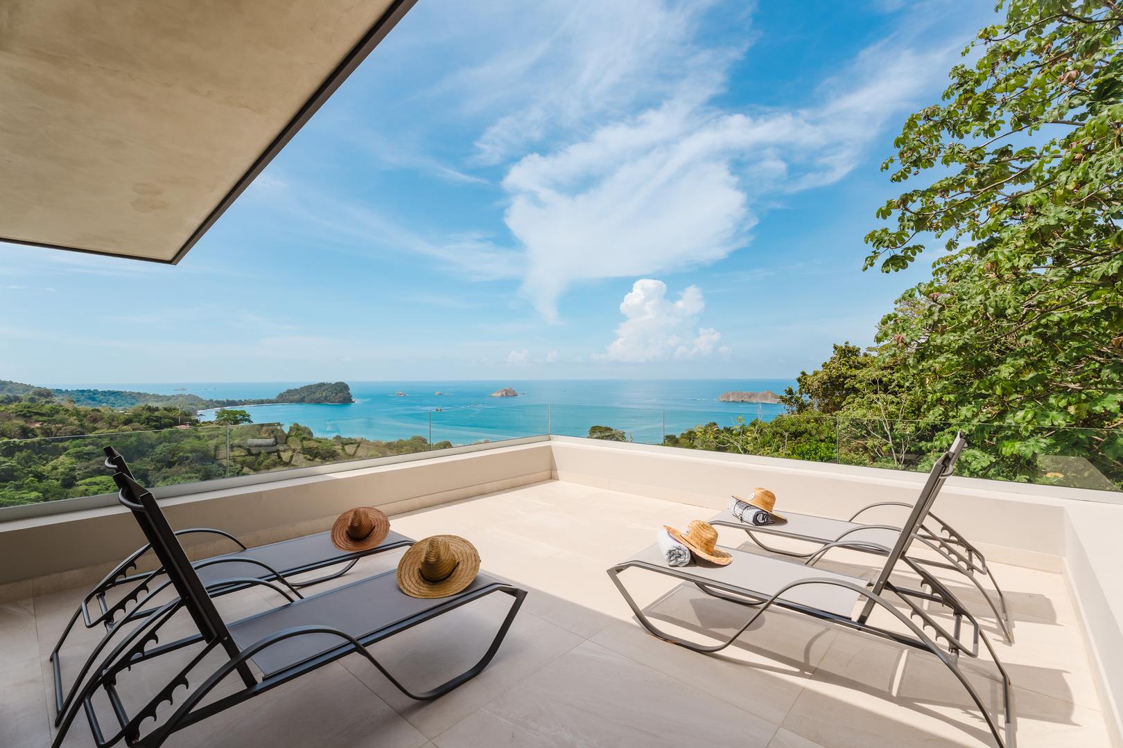 Sun loungers on a terrace overlooking the Pacific Ocean and coastline in Manuel Antonio Costa Rica