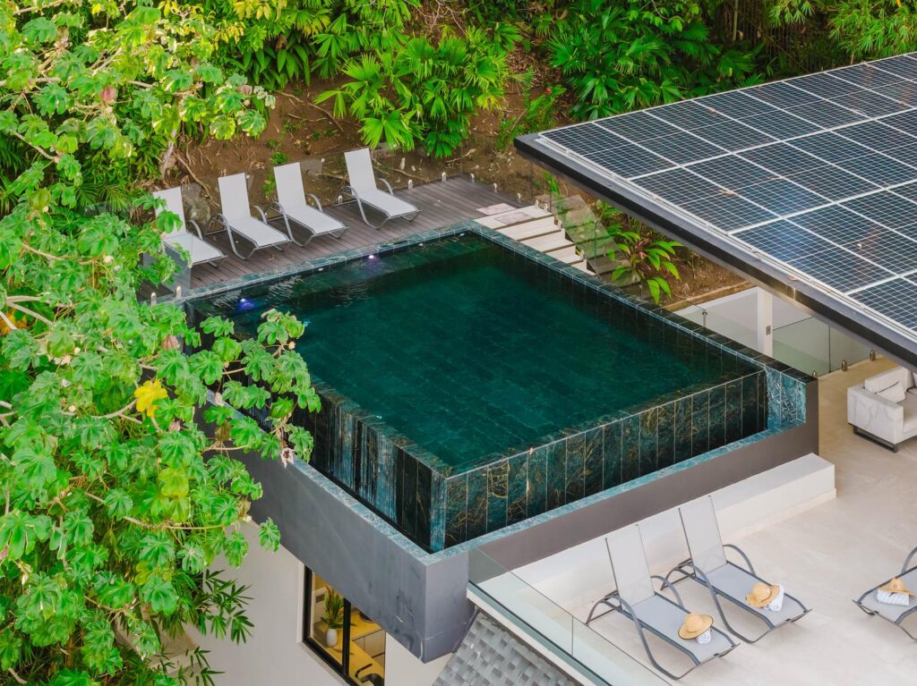 An elevated pool deck surrounded by lush greenery and quiet seclusion.
