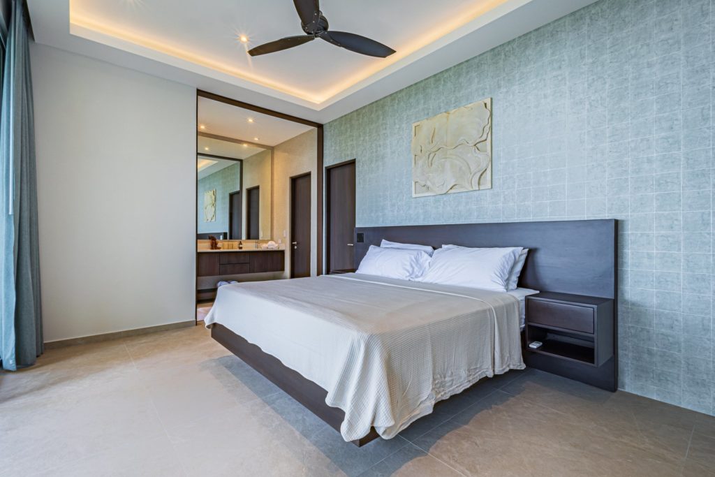 There are four luxurious bedrooms with beautiful wooden furniture, ensuite bathrooms, and private terraces.
