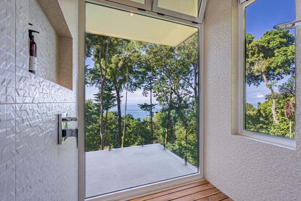 Enjoy a relaxing shower as you take in the breathtaking rainforest and ocean views.