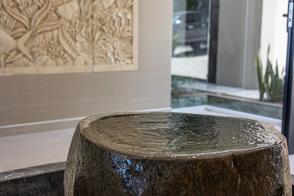 This natural stone water feature sets the tone for the laid-back luxury vibe of this incredible vacation home.