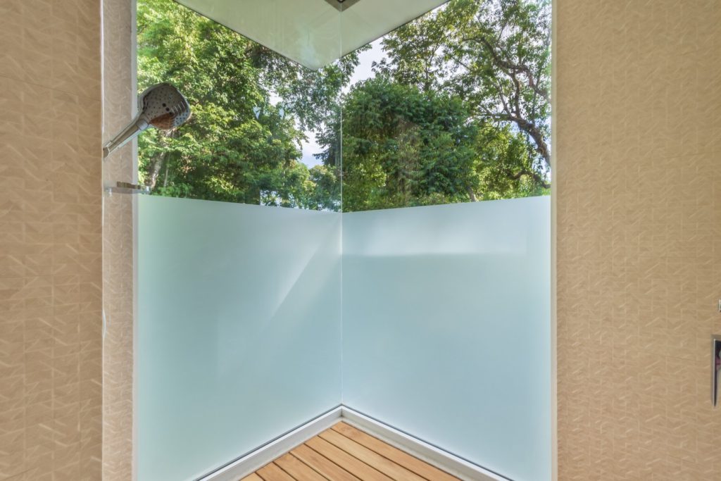 Enjoy vibrant rainforest views from your spacious luxury shower.