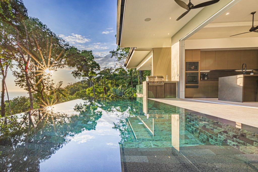 The stunning infinity pool is the perfect vantage point to watch as the setting sun shines through the lush jungle.