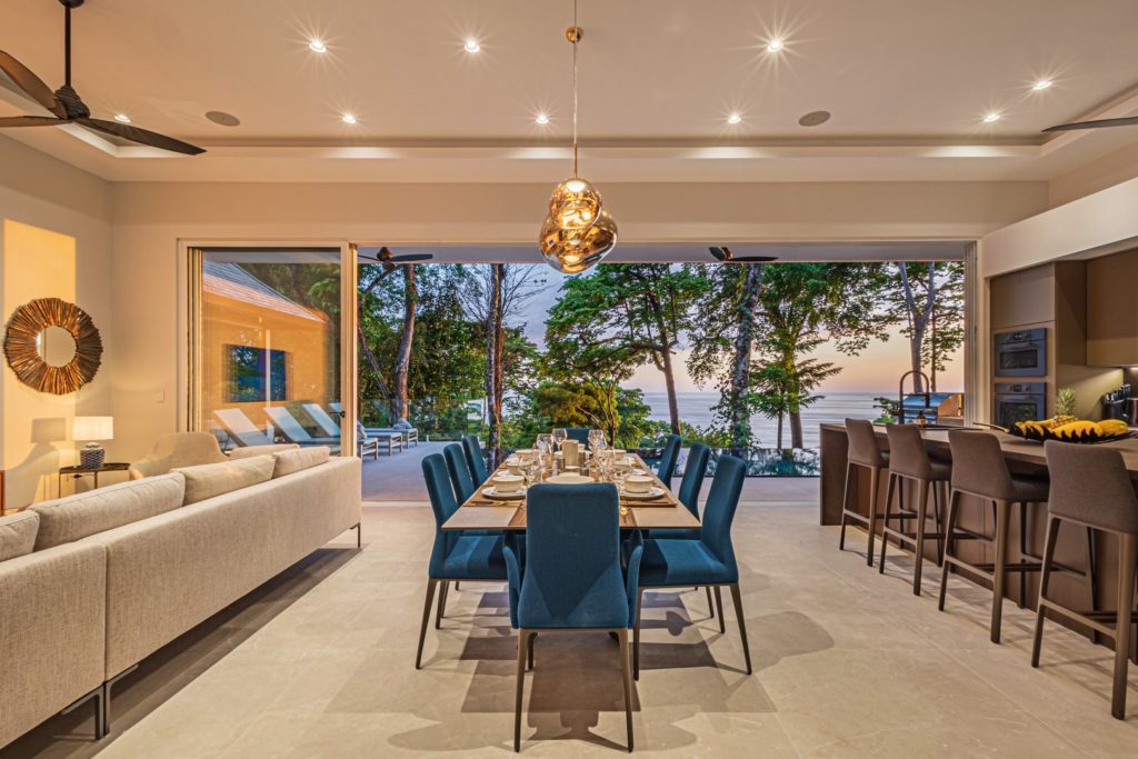 The huge open-plan living dining and kitchen area is an amazing space for gathering with an awe-inspiring ocean vista.