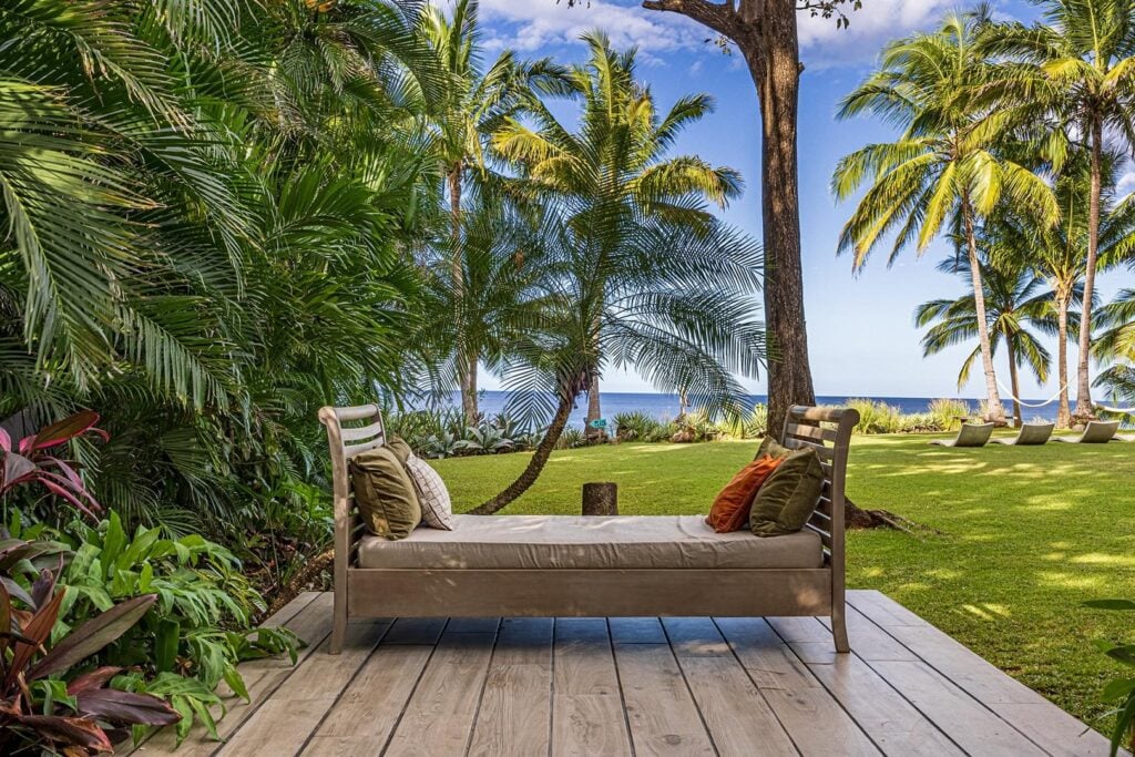 Curl up in the shade with a good book on this luxury daybed overlooking the garden.
