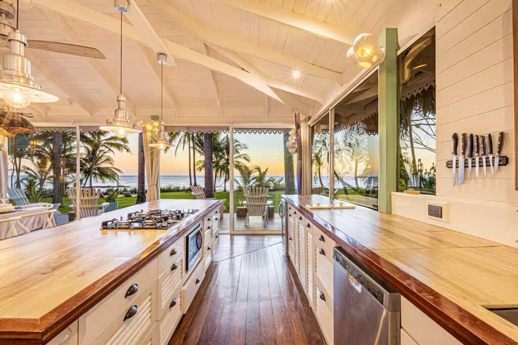 Your modern kitchen has high-end appliances and lots of natural wooden work tops.