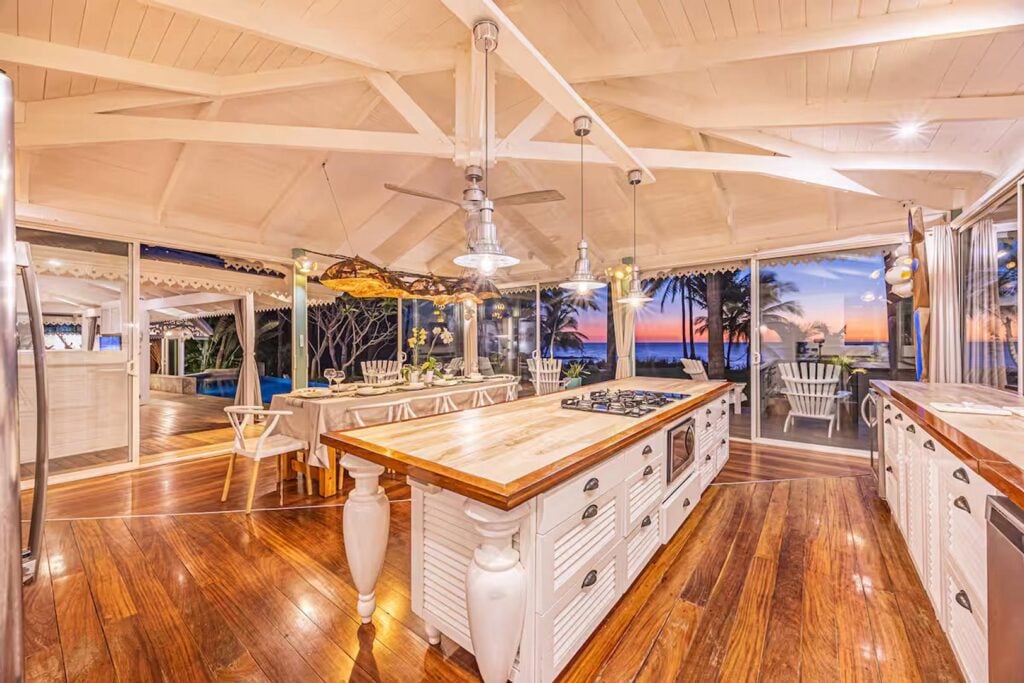 The spacious kitchen and dining area offers views to the pool and ocean with huge glass sliding doors.