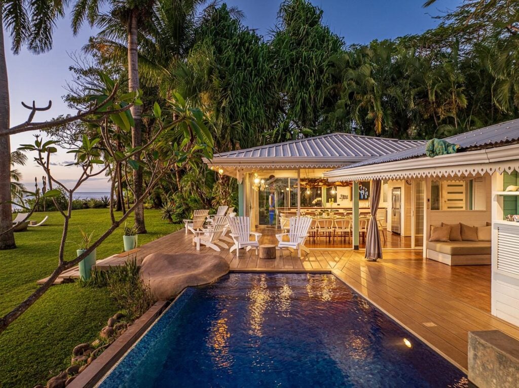 As the lights go on in the pool and the villa, this gorgeous vacation home starts to glow warmly in an inviting way.