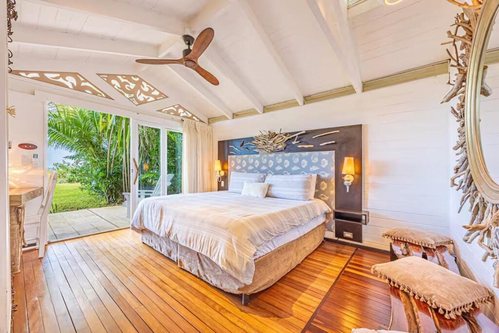 Driftwood and hand-carved details in this bedroom add natural and classical elements to the superb interior design.