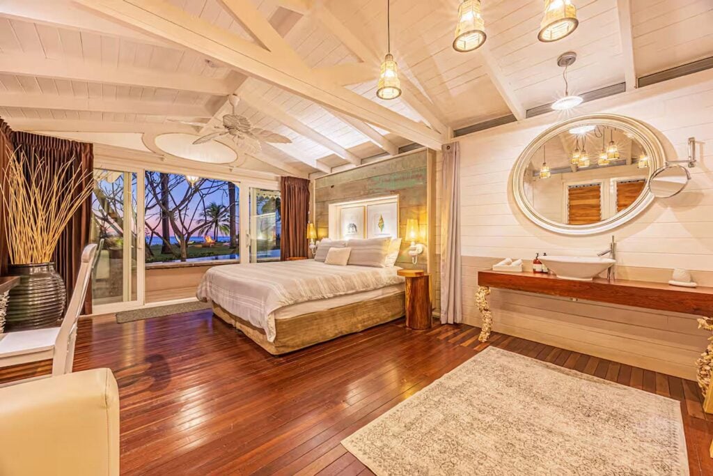 The luxurious master bedroom makes full use of its space and is filled with chic and rustic charm.