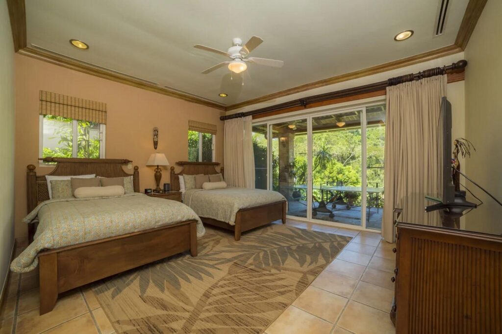 This bedroom opens up to the terrace with views of the golf course.