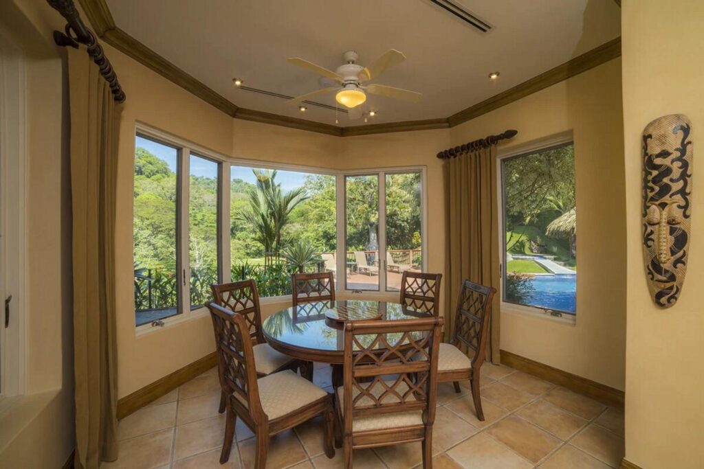 Dine in comfort at this dining table surrounded by tropical views.