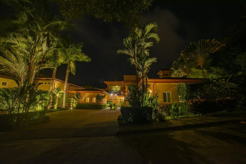 At night, the entrance to the house lights up in a warm and inviting way.