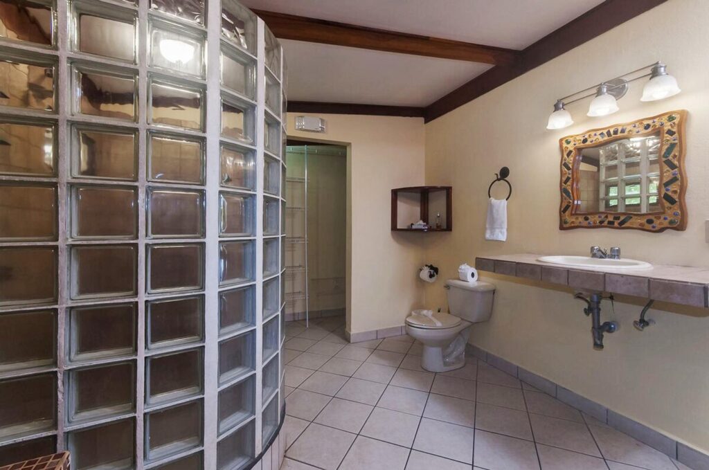 Sleek, clean bathrooms with a hint of rustic, tropical style.