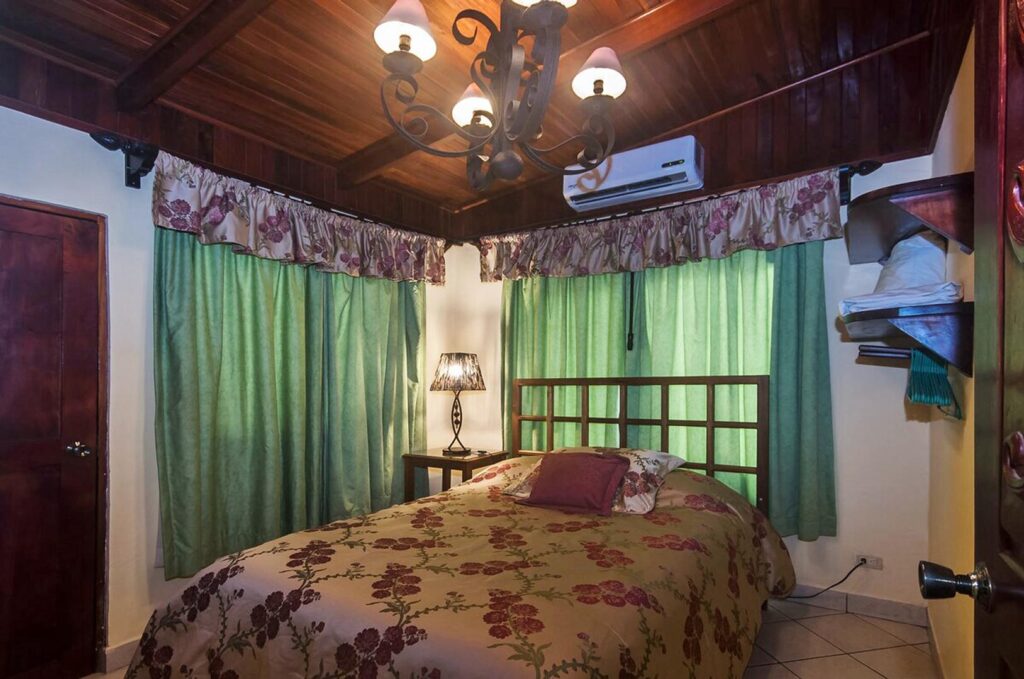 Air-conditioned bedrooms with elegant high wood ceilings.