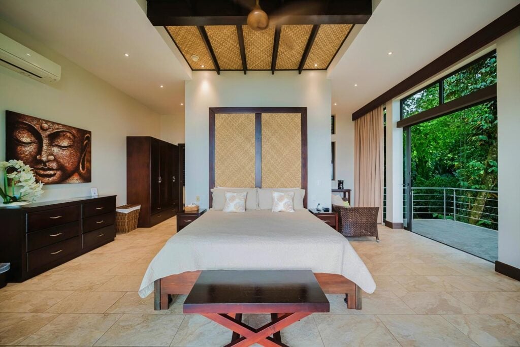 A serene master suite offers privacy and calm while still connected to the tropical setting.