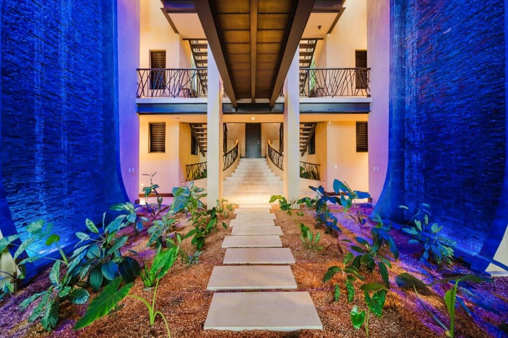Step inside to the soothing sound of cascading water and lush tropical design.