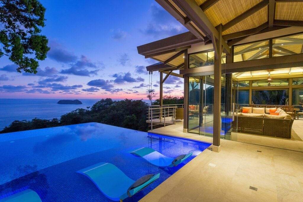 Evenings are magical with the pool lit against the jungle backdrop.