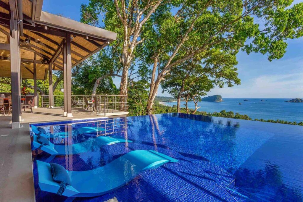 Sunbathe in style on in-pool loungers with the ocean just beyond.