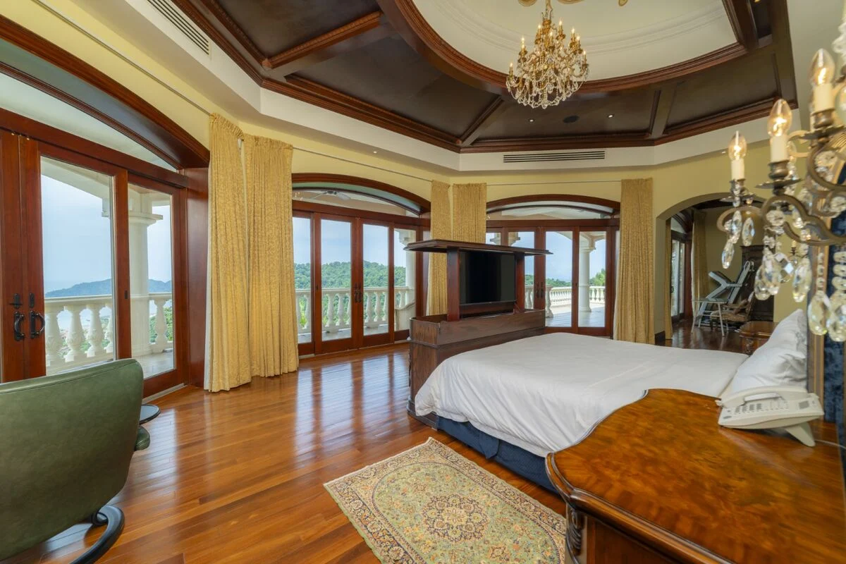 luxury villa bedroom in los suenos with balcony ocean view wood floors and chandelier