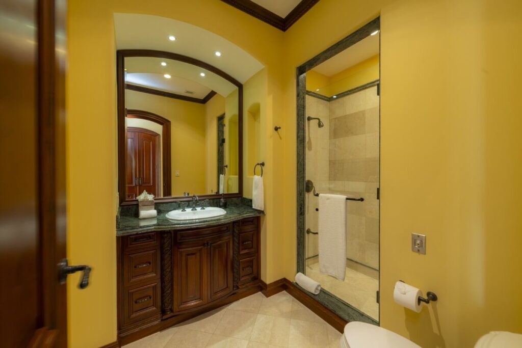 A well-appointed bathroom with clean finishes and a walk-in shower, designed for comfort and everyday ease.