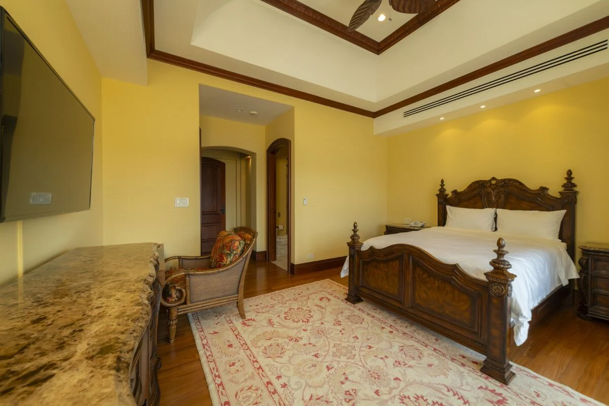 luxury villa bedroom in los suenos with high ceiling wood bed furniture and seating area