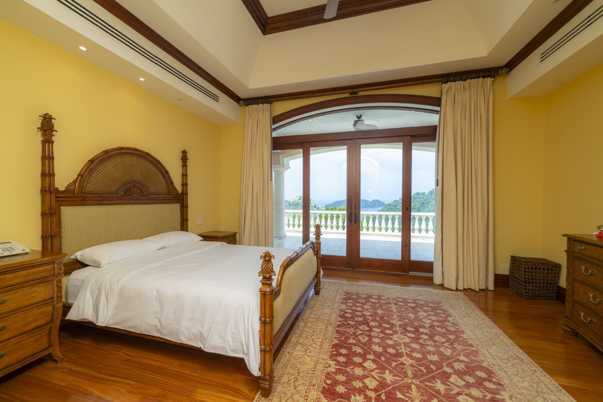 luxury villa bedroom in los suenos with terrace access ocean view wood furniture and large doors