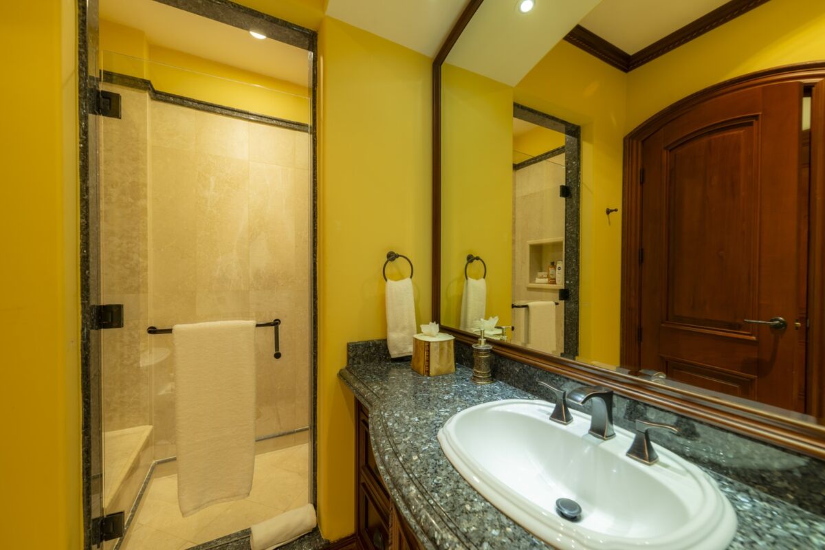 luxury villa bathroom in los suenos with granite vanity sink mirror and glass shower