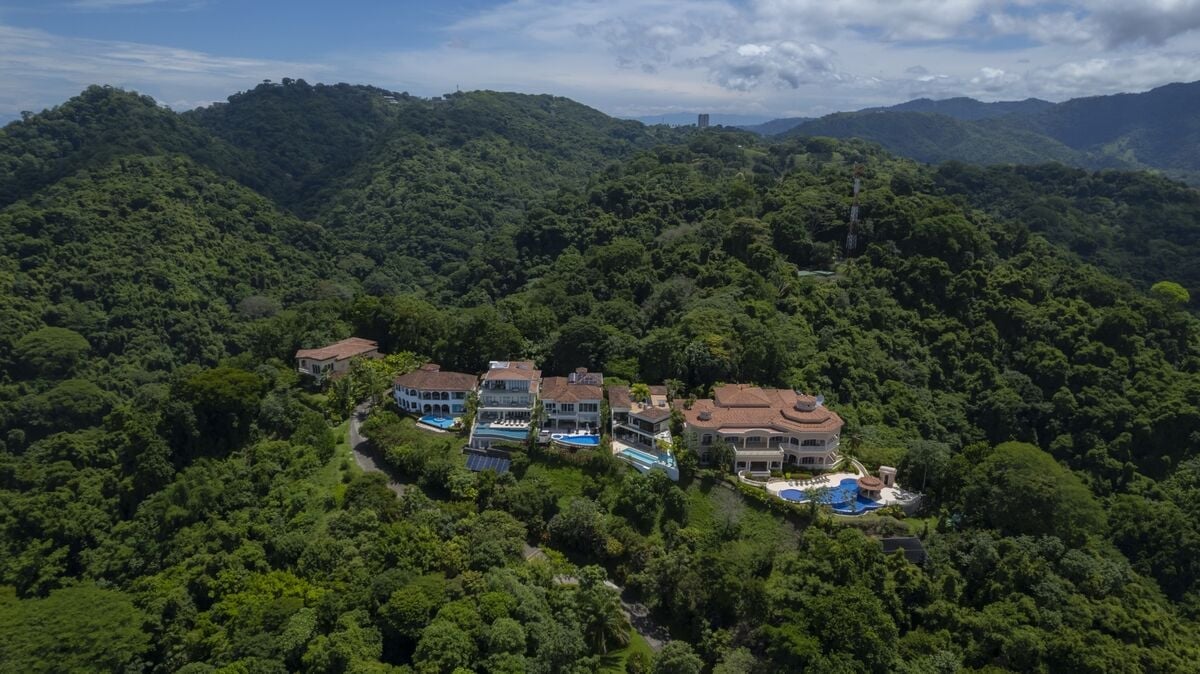 aerial view of luxury villas in los suenos surrounded by rainforest hills and tropical landscape