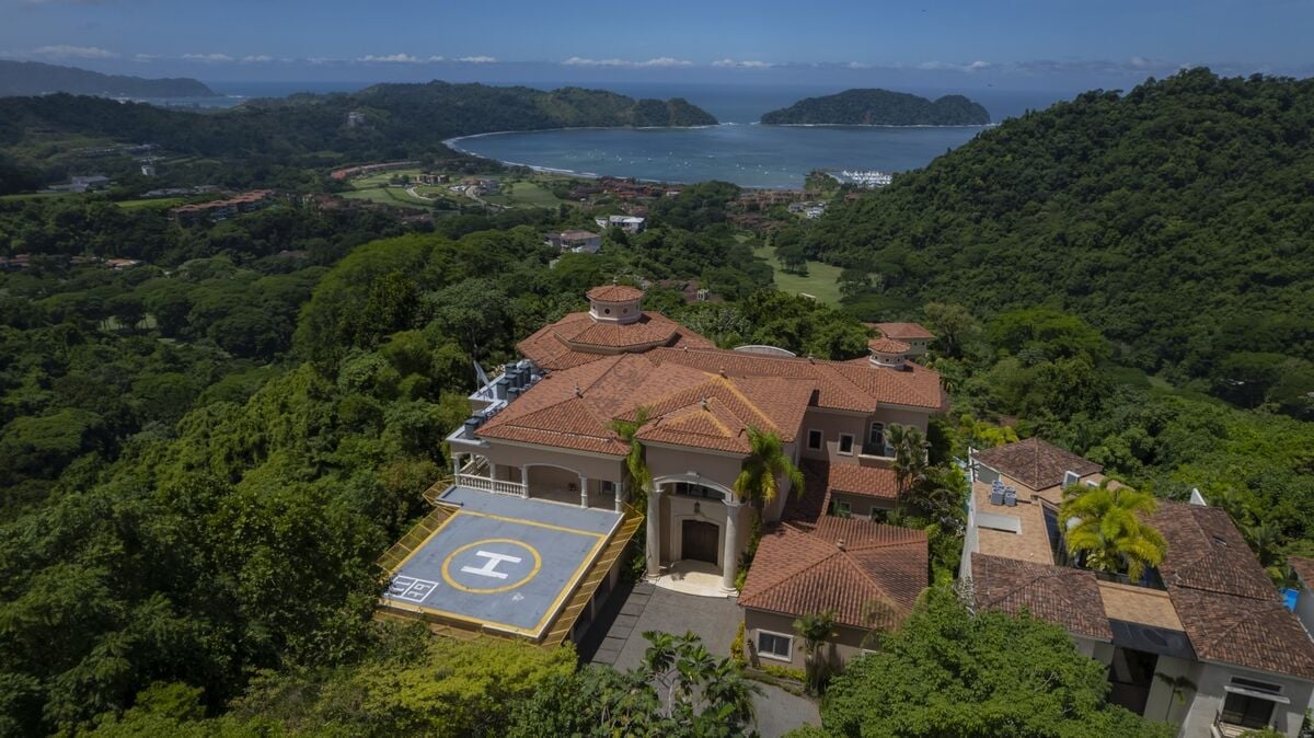aerial view of luxury villa in los suenos with private helipad overlooking bay and rainforest