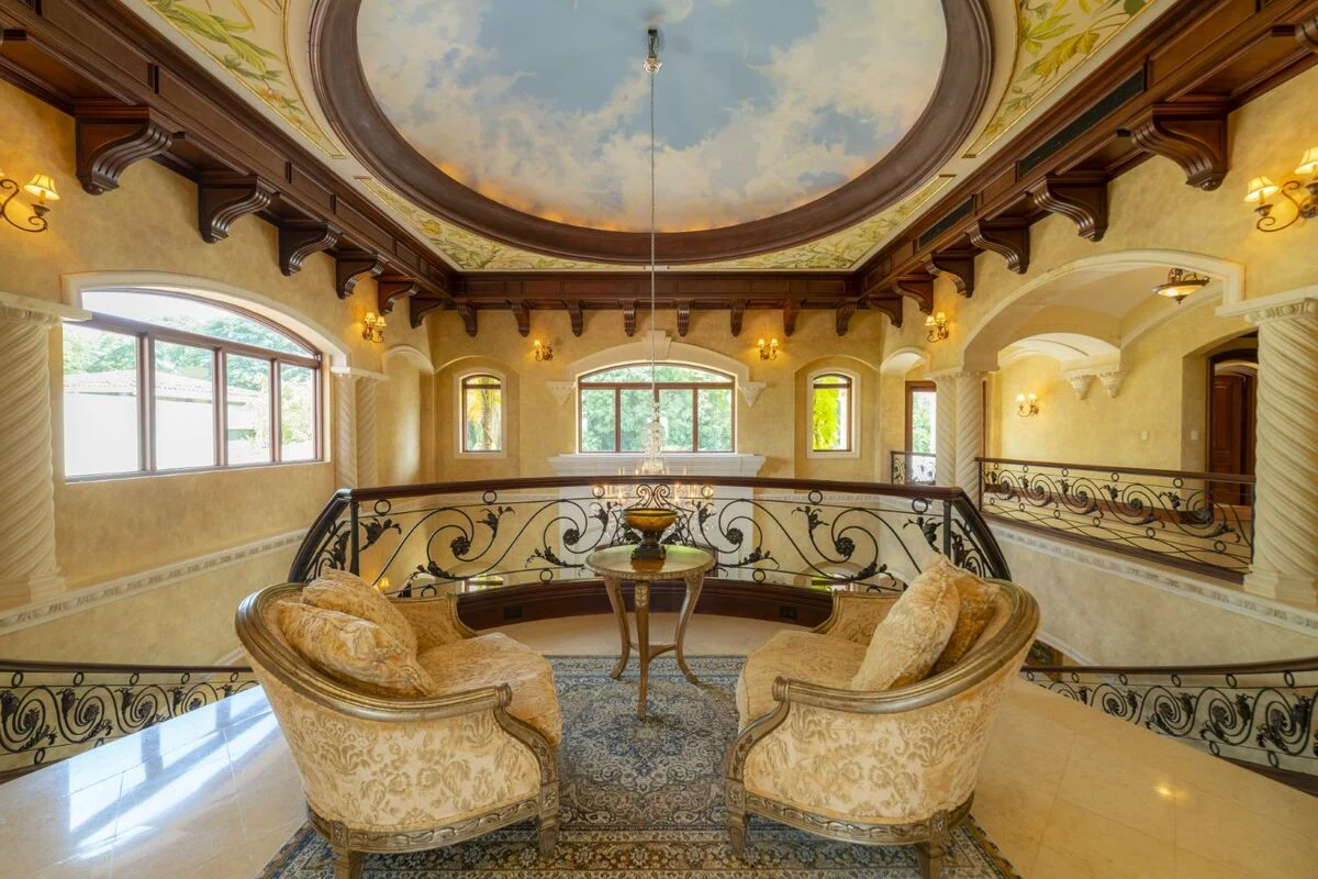 luxury villa upper level lounge in los suenos with dome ceiling seating area and wrought iron railing